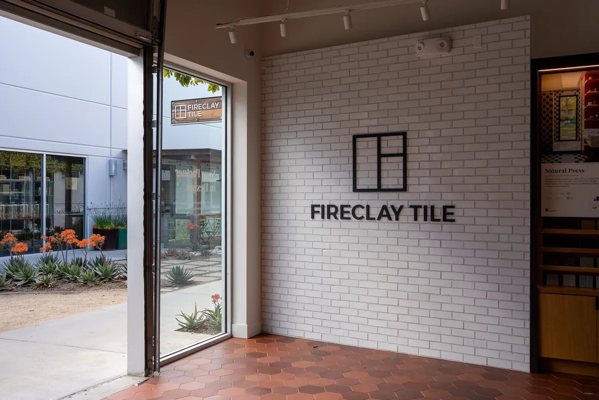 Fireclay Showroom Costa Mesa Entry White Brick Wall with Fireclay Tile Logo