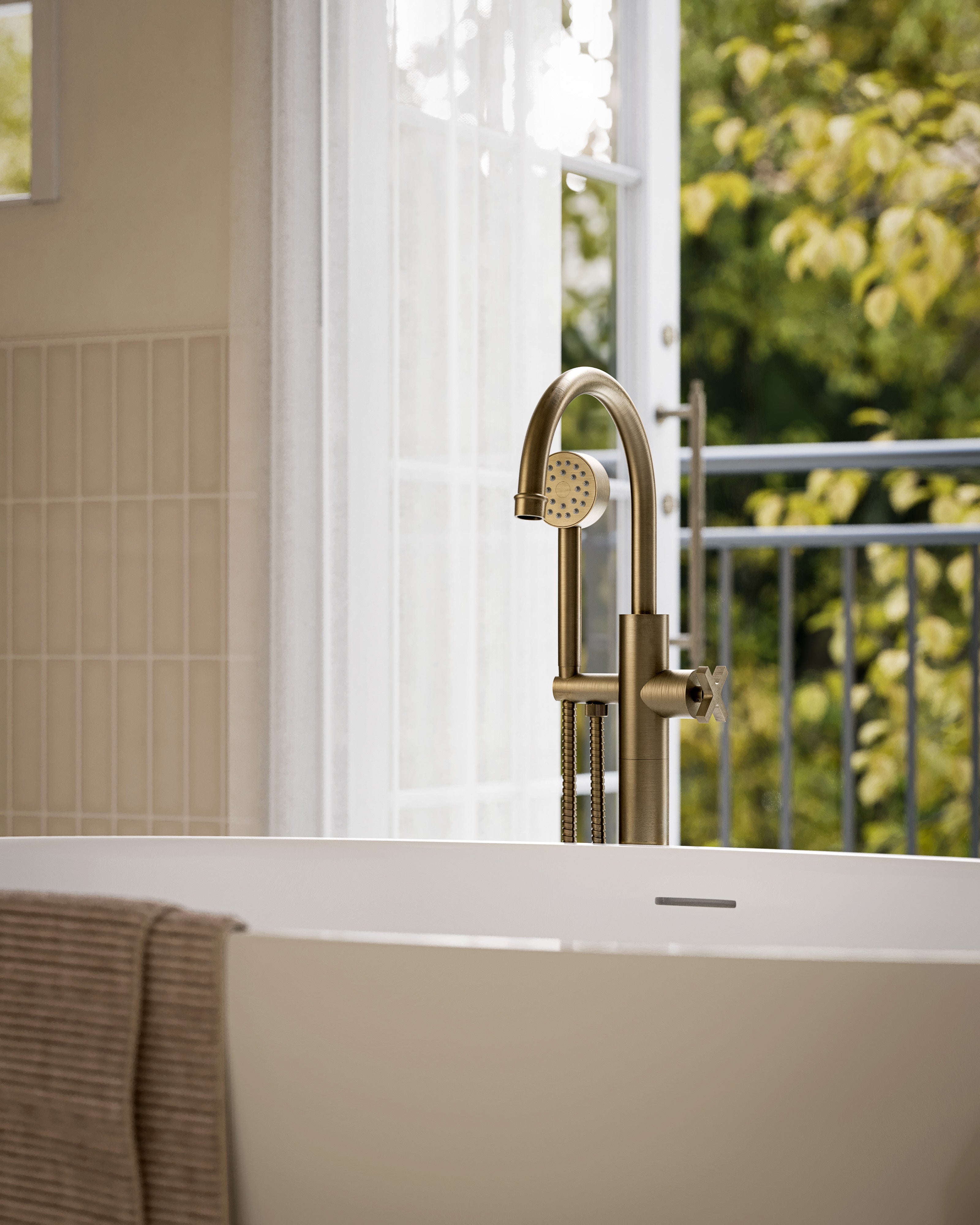 Emerson One Handle Floor Mount Gooseneck Bath Trim with Hand Shower and Classic Cross Handle in Antique Brass
