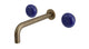 Foundry Two Handle Wall Mount 7.5" Lavatory Faucet with Pebble Ceramic Knob Handles in Antique Brass