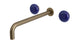 Foundry Two Handle Wall Mount 12" Lavatory Faucet with Pebble Ceramic Knob Handles in Antique Nickel
