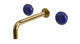 Foundry Two Handle Wall Mount 7.5" Lavatory Faucet with Pebble Ceramic Knob Handles in Uncoated Polished Brass